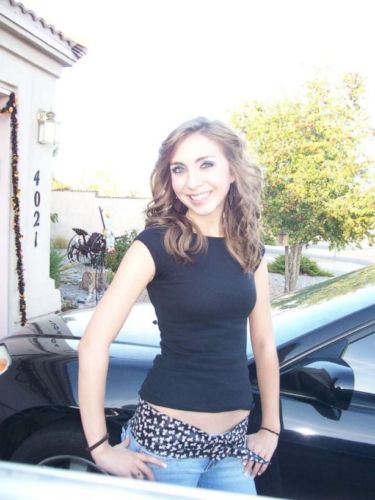 Brittani Marcell standing next to a car