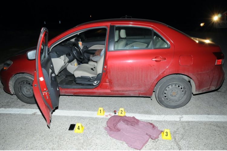 car with crime scene markers outside