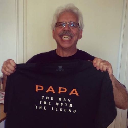 Steven Gerecke holding a "papa" t-shirt
