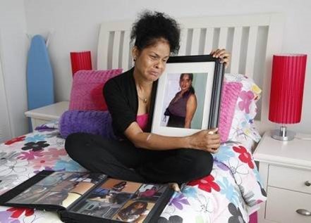 Camile Hamilton holding a picture of one of the victims