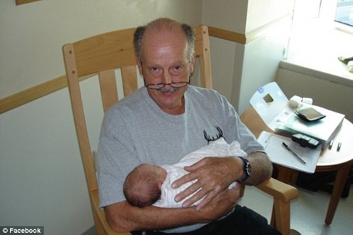 William Mussack holding a baby